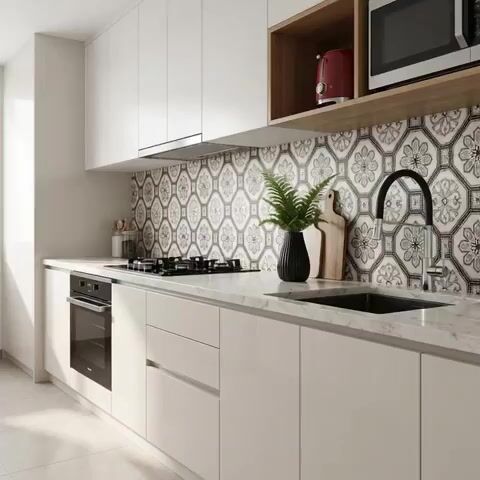 Modern kitchen walkthrough with white laminate cabinets, marble-look countertop, and black-and-white geometric floral backsplash tiles