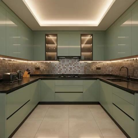 Modern U-shaped kitchen with sage green laminate, black quartz countertop, and metallic mosaic backsplash tiles in Bengaluru