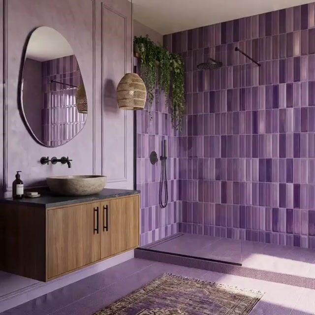 Modern bathroom walkthrough with purple subway wall tiles, matte lavender floor tiles, and wood vanity