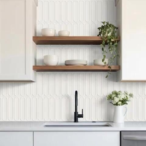 Minimalist kitchen walkthrough with white kitkat wall tiles, white quartz countertop, and wooden open shelves