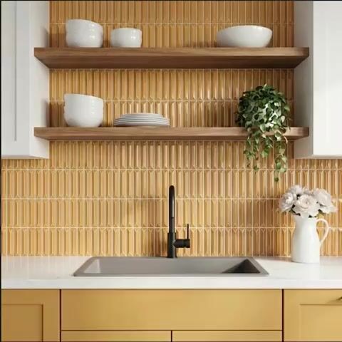 Modern kitchen walkthrough with mustard yellow kitkat backsplash tile, white quartz countertop, and wooden open shelves