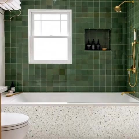 Modern bathroom walkthrough with green square wall tiles and terrazzo bathtub cladding