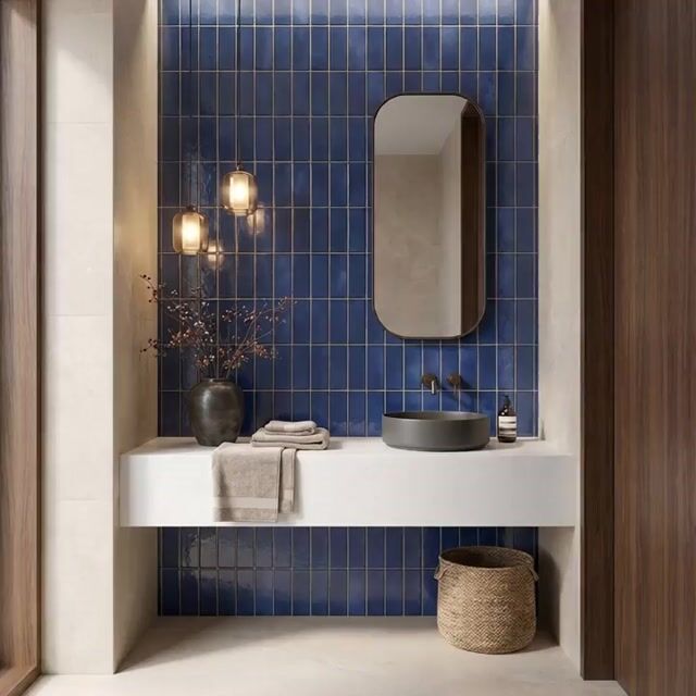 Modern bathroom walkthrough with blue vertical subway wall tiles and white quartz countertop