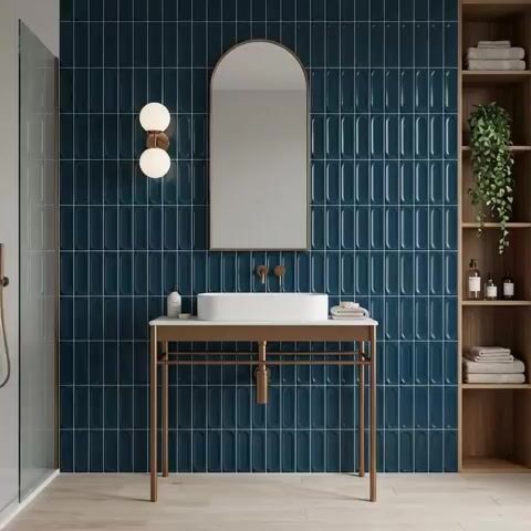 Modern bathroom walkthrough with deep blue kitkat wall tiles and light wood floor tile