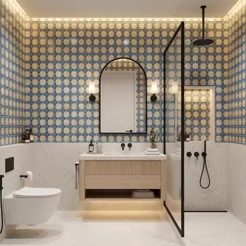 Modern bathroom walkthrough with blue and beige geometric patterned wall tiles and terrazzo floor