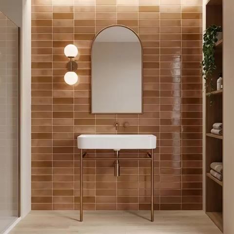 Minimalist bathroom walkthrough with terracotta subway wall tiles and light wood floor tile