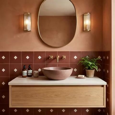 Minimalist bathroom walkthrough with terracotta patterned wall tiles and light oak floating vanity