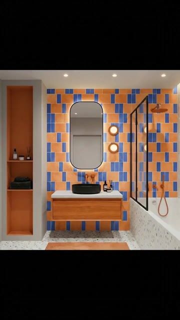 Modern bathroom walkthrough with orange and blue geometric wall tiles, terrazzo floor, and wood vanity