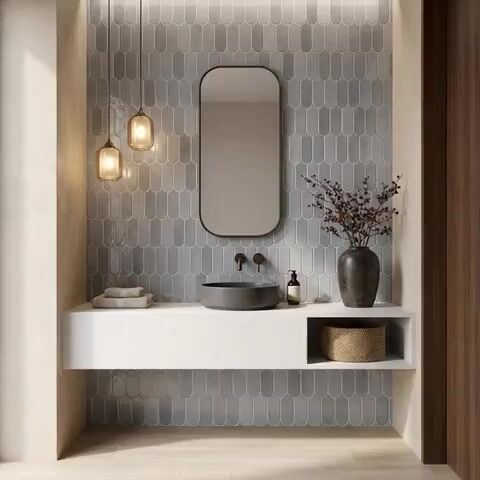 Minimalist bathroom walkthrough with grey scallop wall tiles and white quartz floating vanity