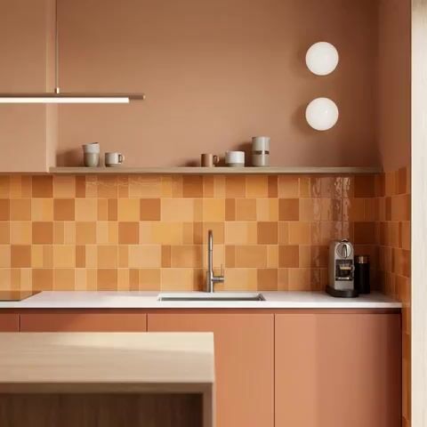 Scandinavian kitchen walkthrough with terracotta laminate cabinets and orange square backsplash tiles