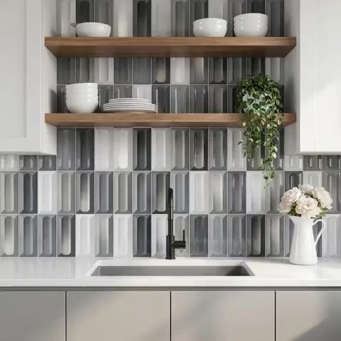 Modern kitchen walkthrough with geometric grey and white backsplash tile, white quartz countertop, and wooden open shelves