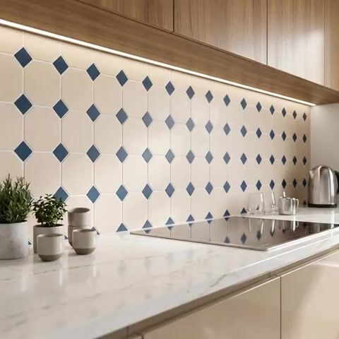 Modern kitchen walkthrough with beige and blue geometric backsplash tile, white marble countertop, and walnut wood laminate cabinets