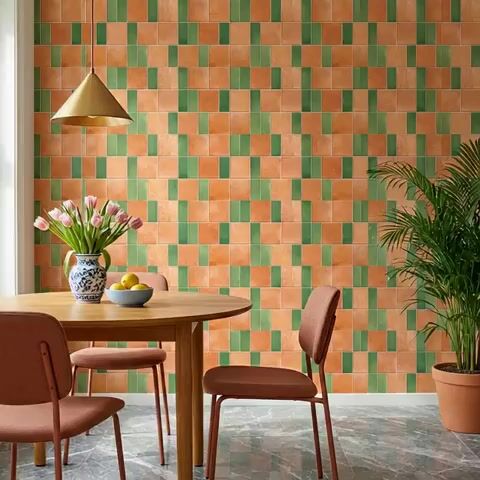 Modern dining room with terracotta and green patterned wall tiles and marble floor