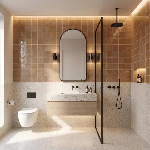 Modern bathroom walkthrough with terracotta wall tiles, terrazzo floor and wall tiles, and floating wood vanity