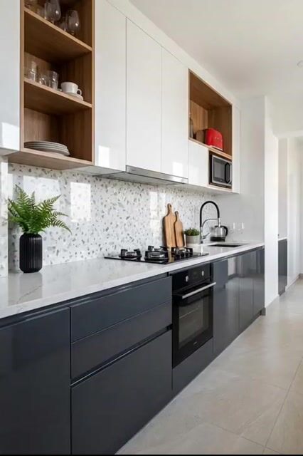 Modern kitchen with white and grey high gloss laminate, terrazzo backsplash tile, and white quartz countertop