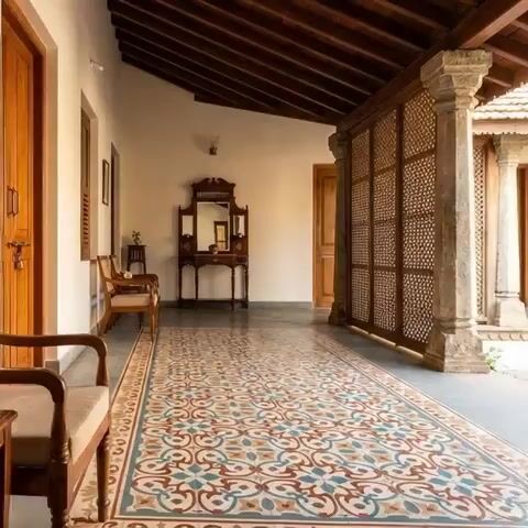 Traditional balcony with patterned encaustic floor tiles and wooden ceiling