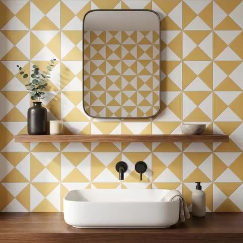 Modern bathroom walkthrough with yellow and white geometric wall tiles and wooden countertop