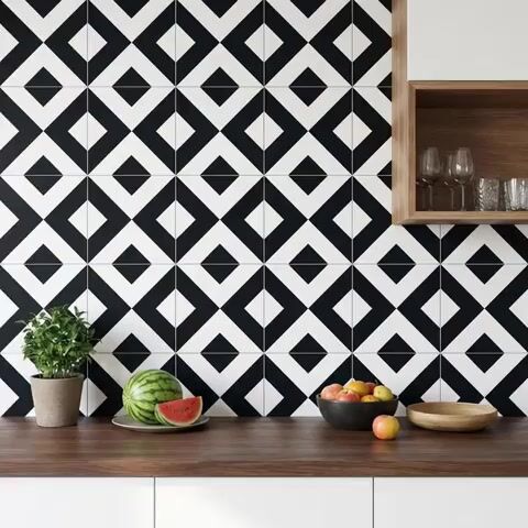 Modern kitchen walkthrough with black-and-white geometric backsplash tiles and walnut wood countertop