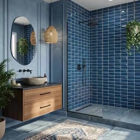 Modern bathroom walkthrough with blue subway wall tiles, wooden floating vanity, and stone countertop
