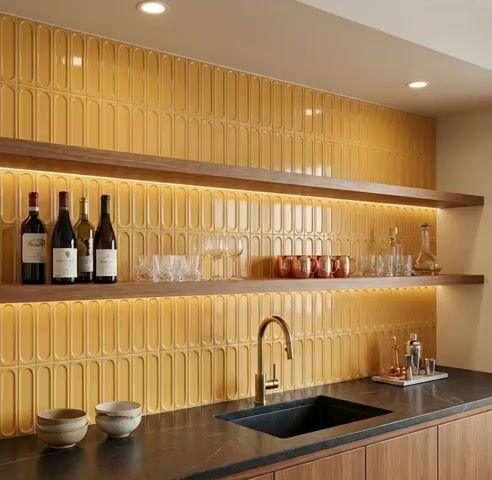 Modern kitchen walkthrough with mustard yellow popsicle wall tiles and black marble countertop