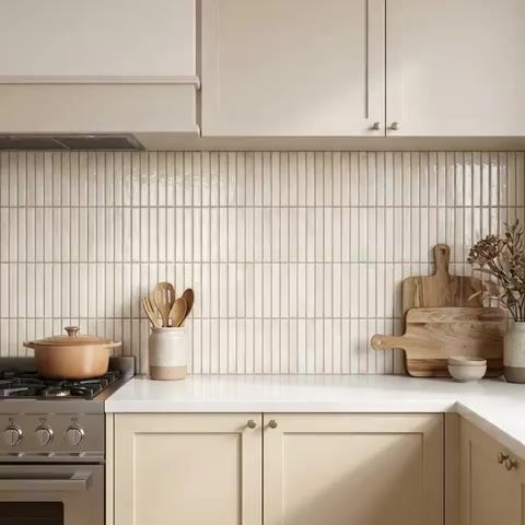 Scandinavian kitchen walkthrough with cream laminate cabinets, white quartz countertop, and vertical kitkat backsplash tiles