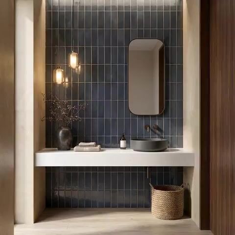Modern bathroom walkthrough with navy blue vertical subway wall tiles and white quartz countertop