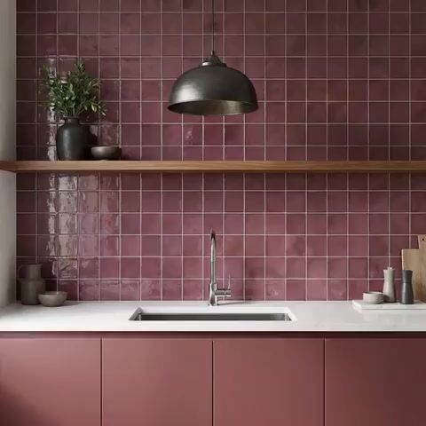 Modern kitchen walkthrough with mauve square wall tiles, matte mauve laminate cabinets, and white quartz countertop